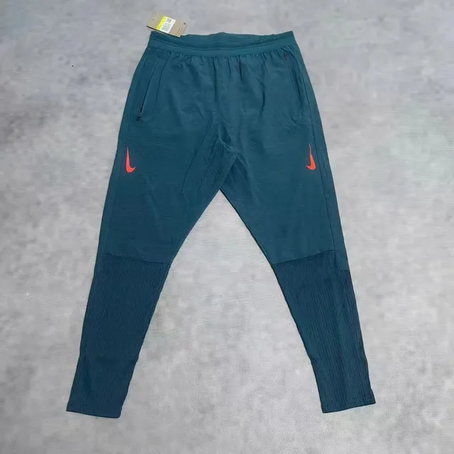 Nike Tech Knit Joggers Deep Teal with Orange Swoosh
