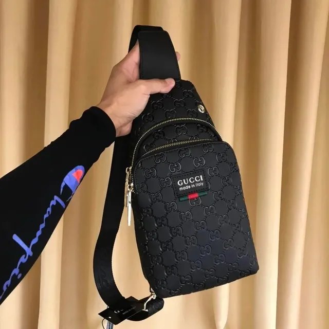 Gucci shoulder bag black embossed GG monogram with gold-tone hardware and signature web stripe patch