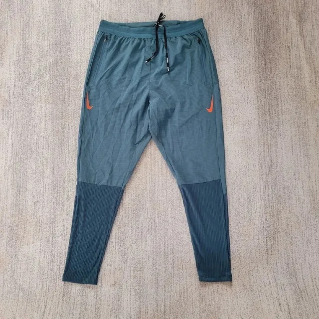 Nike Tech Pack Trousers Teal with Orange Swoosh