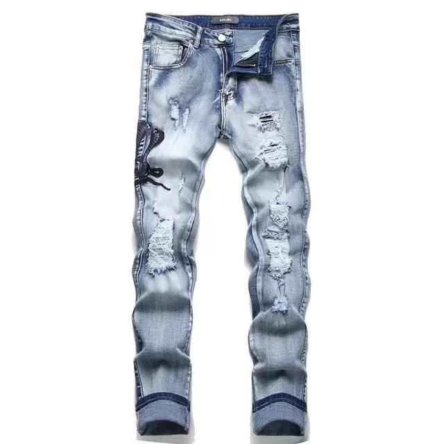 Amiri Distressed Jeans Ripped with Embroidered Patch