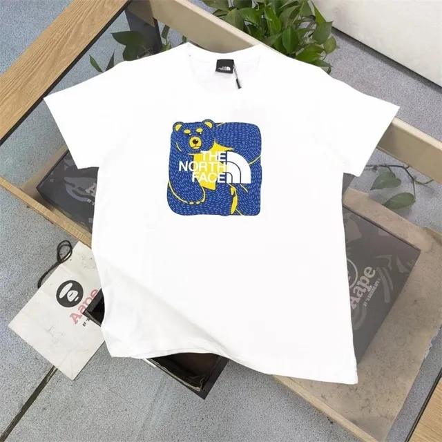 The North Face T-shirt blue bear graphic with TNF mountain logo and camo dot pattern
