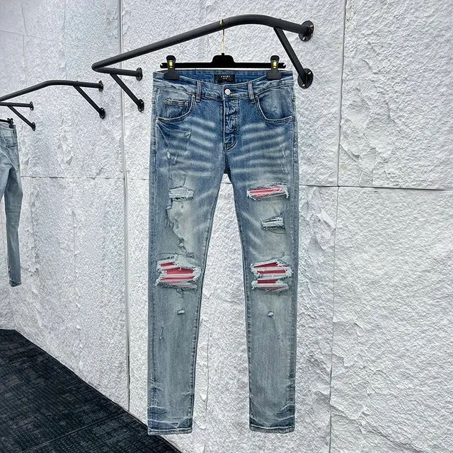 Amiri Distressed Slim Fit Jeans Ripped with Red Stripe Detail