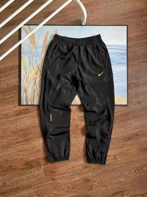 Nike × NOCTA Windrunner Joggers Black with Gold Swoosh