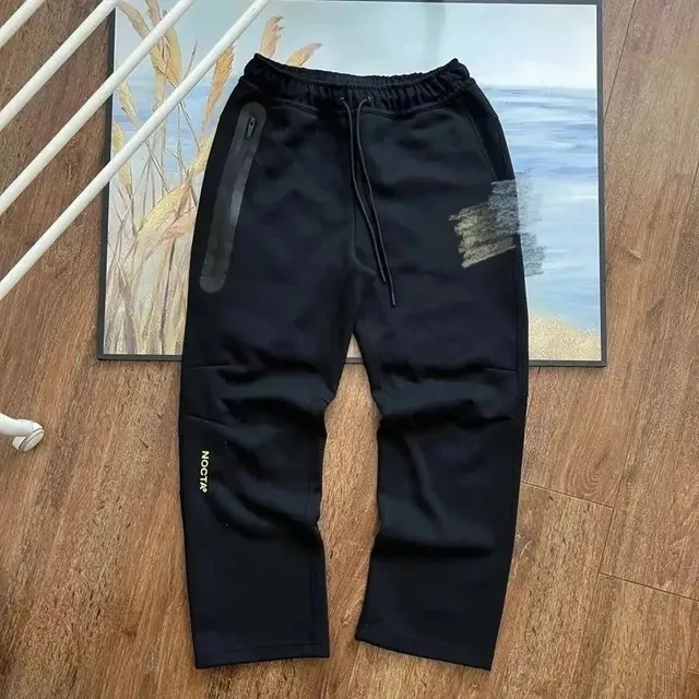 NOCTA Tech Fleece Joggers Black with Gold Logo