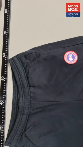 Black pants with red label